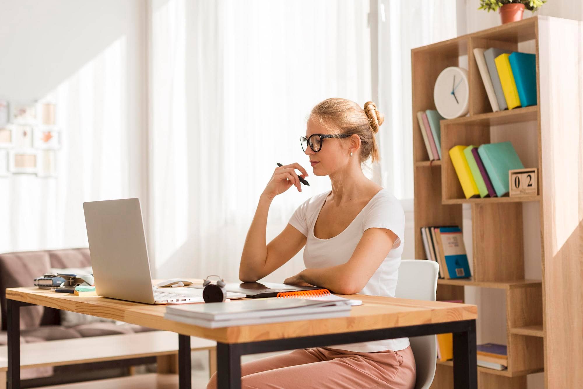 side-view-woman-working-laptop-from-home-desk